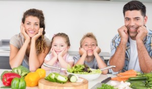 Cheerful family preparing vegetables together
